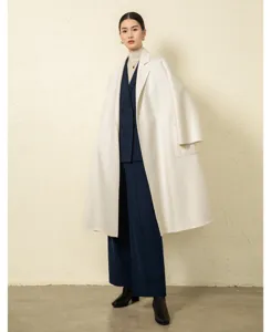 Cashmere wrap coat detail view highlighting premium double-sided wool texture and fine tailoring.