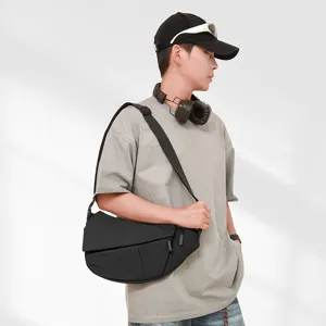 Street fashion asymmetric crossbody bag for men, versatile black chest bag, casual daily use.