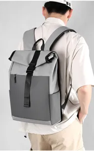 Stylish grey waterproof roll-top backpack with large capacity and secure buckle for daily commuting.
