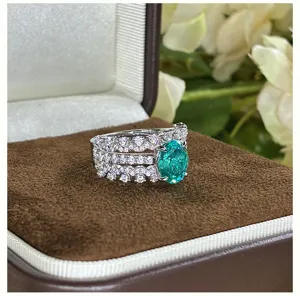 Stunning oval synthetic Paraiba gemstone multi-layer diamond ring in 925 silver detail shot