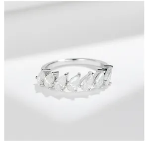 Close-up detail of silver pear cut moissanite half eternity ring sparkling stones jewelry