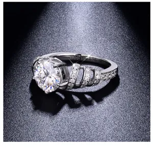 Detail view of brilliant moissanite ring showcasing sparkling center stone and paved band.