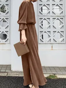 Solid brown long caftan dress detail, elegant pleated fabric texture for vintage styling scene.