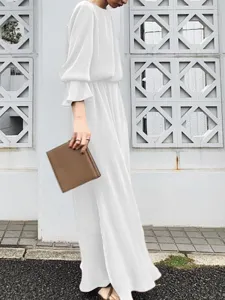Detailed view of elegant solid white long sleeve maxi dress featuring graceful flow.