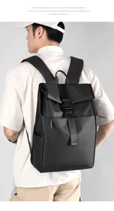 Detailed view of the stylish black roll-top backpack worn by a model, highlighting the front buckle.