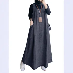Detailed view of the loose casual denim overall dress featuring convenient front pockets.