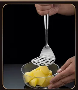 Stainless steel potato masher detail, kitchen tool for easy food prep and mashing potatoes.