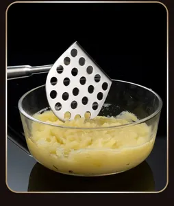 Stainless steel potato masher tool with perforated plate for smooth kitchen prep detail view.