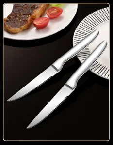 Stainless steel steak knife detail shot, serrated blade with brushed finish for western dining.