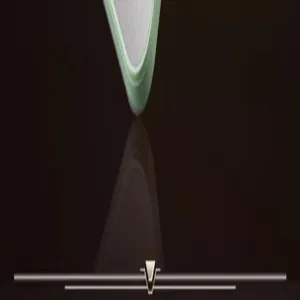 Kitchen vegetable slicer blade detail close-up, stainless steel and green frame design.