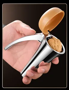 Nutcracker detail view showing ergonomic metal handle and walnut placed inside shell opener.