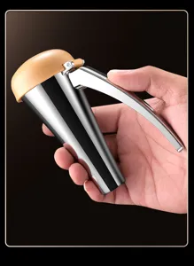 Close-up of the ergonomic metal nutcracker in hand, displaying its durable walnut opening design.