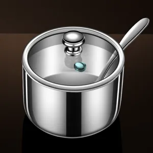 Stainless steel seasoning pot with glass lid and spoon, perfect for kitchen condiment storage.