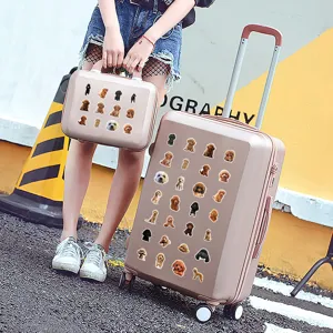 Detailed view of cute poodle cartoon graffiti stickers decorated on pink travel luggage case.