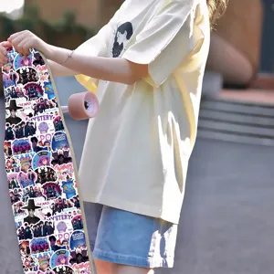 Detailed view of trendy skateboard decorated with colorful K-pop and anime graffiti stickers.
