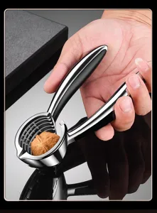 Detail shot of heavy-duty stainless steel nutcracker with ergonomic non-slip handle.