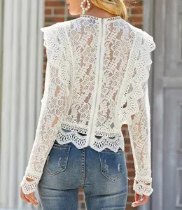 Detailed view of women white lace long sleeve hollow out crop top showing exquisite texture.