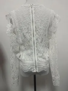 Back view of women white lace long sleeve top with back zipper and hollow floral details.