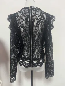 Detail view of a sexy black lace long-sleeve crop top featuring an exposed back zipper.