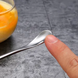 Stainless steel baby mixing spoon with long handle and smooth edge design for daily use.