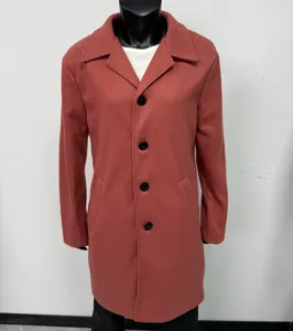 Close-up detail of men's wool blend overcoat with stylish lapel and black buttons.