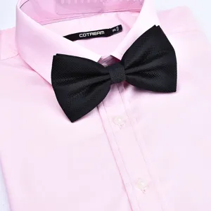 Classic black textured bow tie paired with a pink dress shirt detail view for formal events.