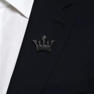 Black crown lapel pin detail view, elegant metal brooch for men suit collar decoration.