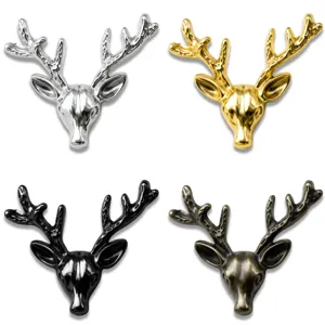 Detail view of deer head brooches, four metallic finishes including silver, gold, black, and bronze.