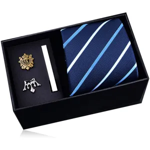 Men's gift box including a blue striped tie, fashion lapel pins and a sleek metal tie clip.