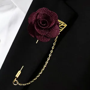 Burgundy glitter fabric rose brooch detail with gold chain and leaf lapel pin display