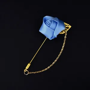 Exquisite blue fabric rose brooch with gold chain and pin, perfect for wedding and event decor.