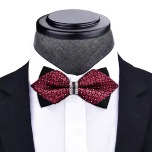 Close-up detail of red patterned bow tie with crystal rhinestone buckle on mannequin shirt.
