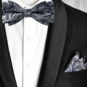 Detailed view of men's black grey paisley bow tie and pocket square set with suit.