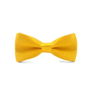Close up detail view of yellow satin children bowtie featuring smooth fabric texture.