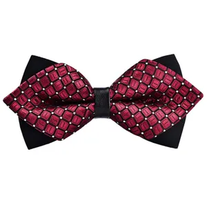 Close-up detail of burgundy grid patterned bow tie with black layered design and center knot.