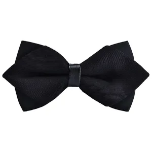 Detailed view of a black pointed bow tie, featuring textured fabric and sleek center band.