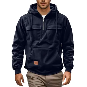 Close-up of men's half-zip hooded sweatshirt detail with multiple pockets and dark blue fabric.