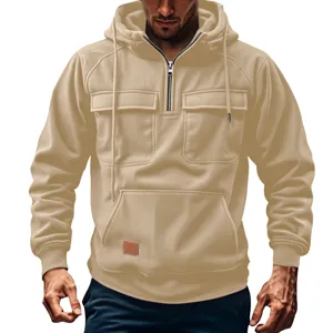 Men's khaki quarter-zip corduroy hoodie detail featuring utility chest pockets and hood.