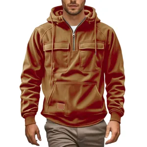 Men corduroy quarter zip hoodie with pockets, detailed view of chest pockets and zipper.