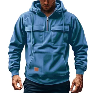 Detailed view of the men's blue ribbed quarter-zip hoodie featuring multiple functional chest pockets.