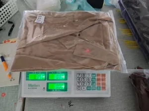 Detail view showing packaged casual women blazer jacket weight display on electronic scale.