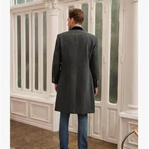 Detailed view of the men's grey wool overcoat showcasing the back design and fit indoors.
