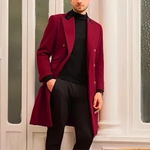 Detail view of men's burgundy double-breasted wool overcoat worn in elegant indoor setting.