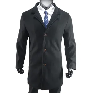 Detail view of the black wool coat lapel, buttons and texture showing exquisite craftsmanship.
