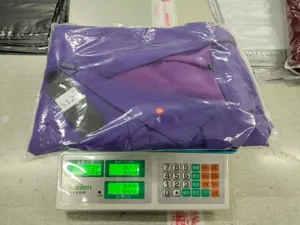 Detail view showing purple men casual suit jacket in packaging and weighing scale setup.