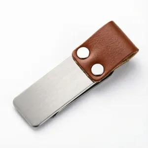 Stainless steel metal clip with brown leather sleeve detail, perfect for notebooks and bills.