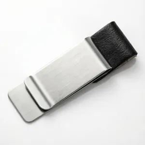Close-up detail of the stainless steel metal and black leather clip, sleek texture and finish.