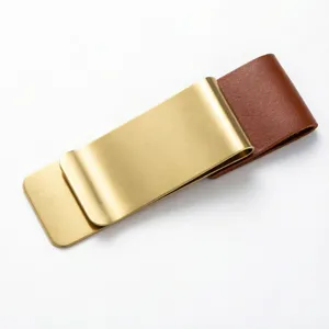 Retro brass money clip with brown leather loop holder for traveler notebook journal and cash.