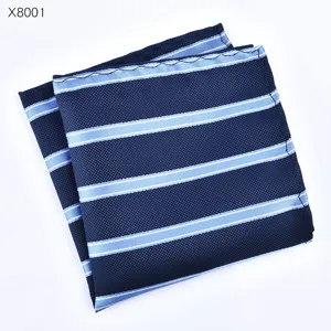 Detailopname van herenpak pochet, elegante donkerblauwe stof met lichtblauwe strepen.