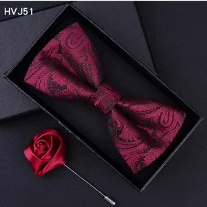 Detail view of the elegant burgundy paisley bow tie and matching rose brooch in gift box.